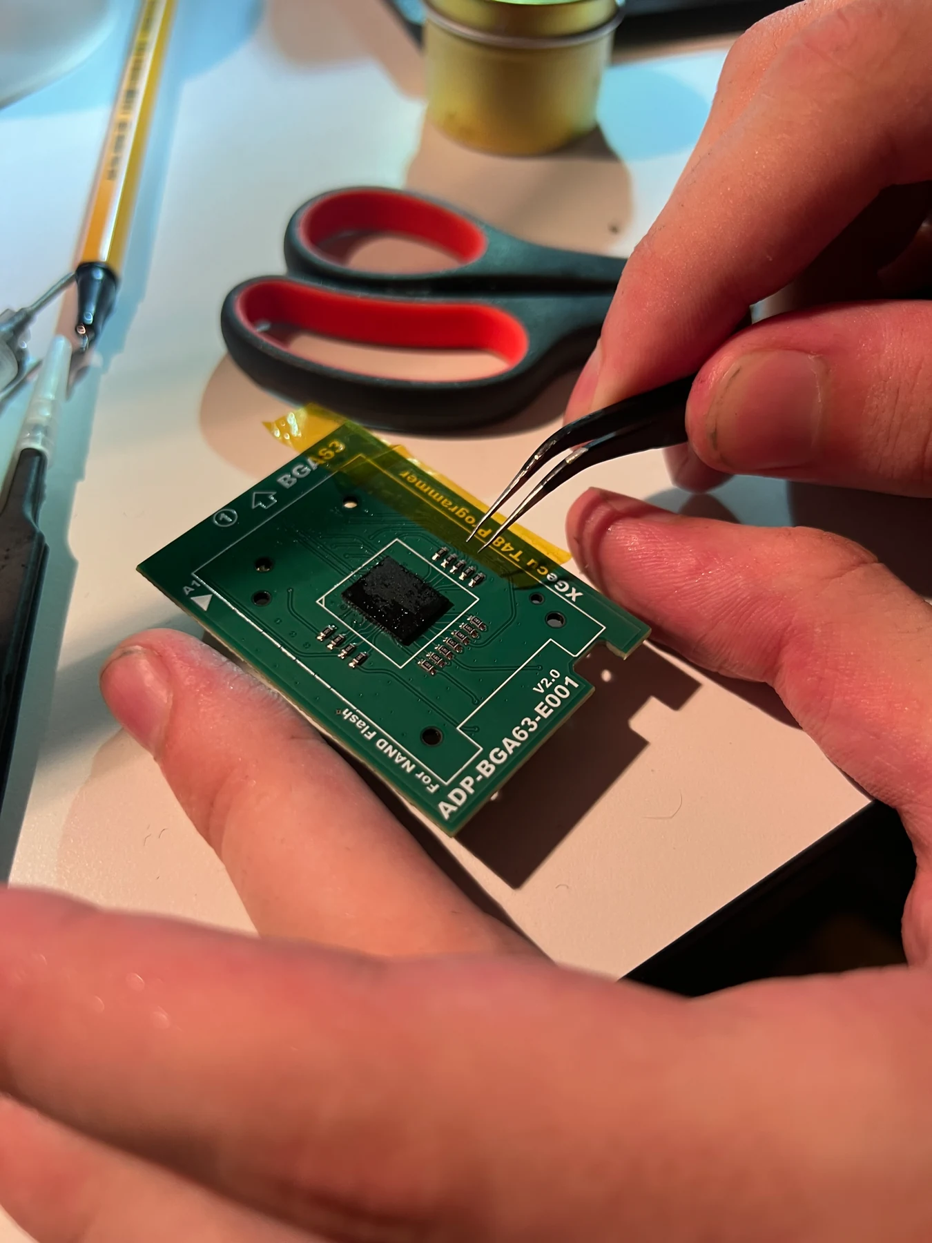 Aligning the reballed NAND on the adapter board under the microscope