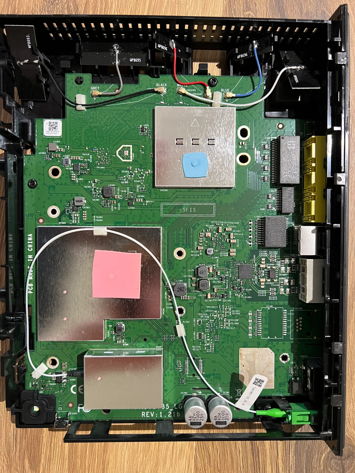 The router mainboard still sitting in the opened enclosure