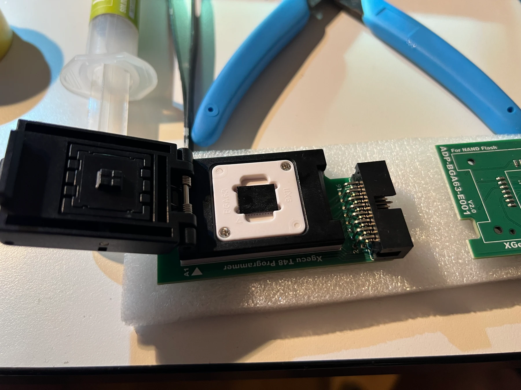 The BGA63 NAND sitting in the white 9x11 mm insert of the spring-loaded socket